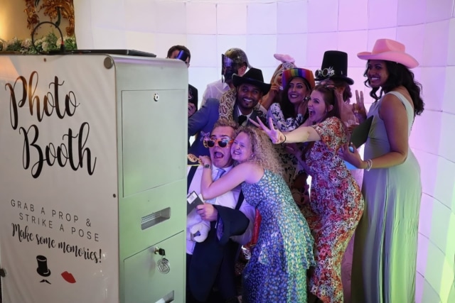 Guests stood in front of an open photo booth